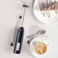 Thumbnail for Black handheld milk frother with stainless-steel whisk – angled view