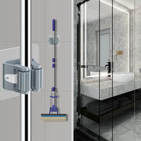 Thumbnail for Wall-mounted mop and broom holder shown in use