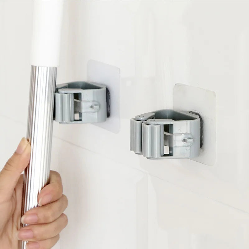 Compact adhesive holder organizing a handled cleaning tool