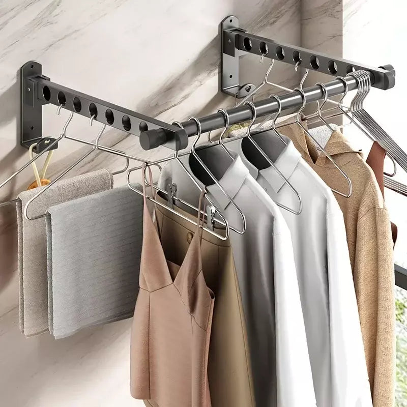 Foldable wall-mounted clothes rack in use